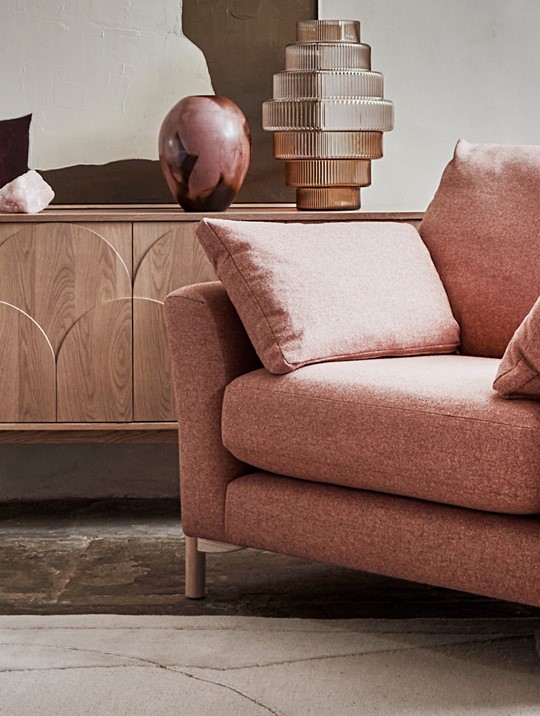 Ercol Avanti Pink Fabric Armchair with Amalfi Sideboard in a Neutral Room
